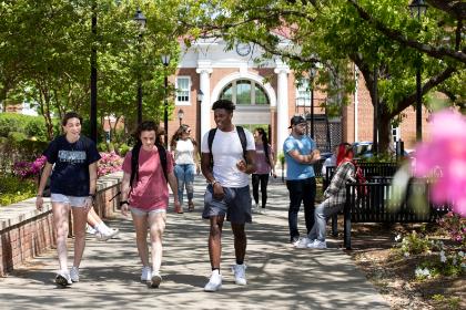 Students walking in front of Maugans with Allen Hall behind