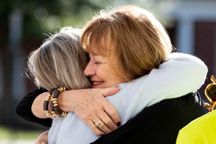 Two Longwood alumnae embrace at Homecoming.