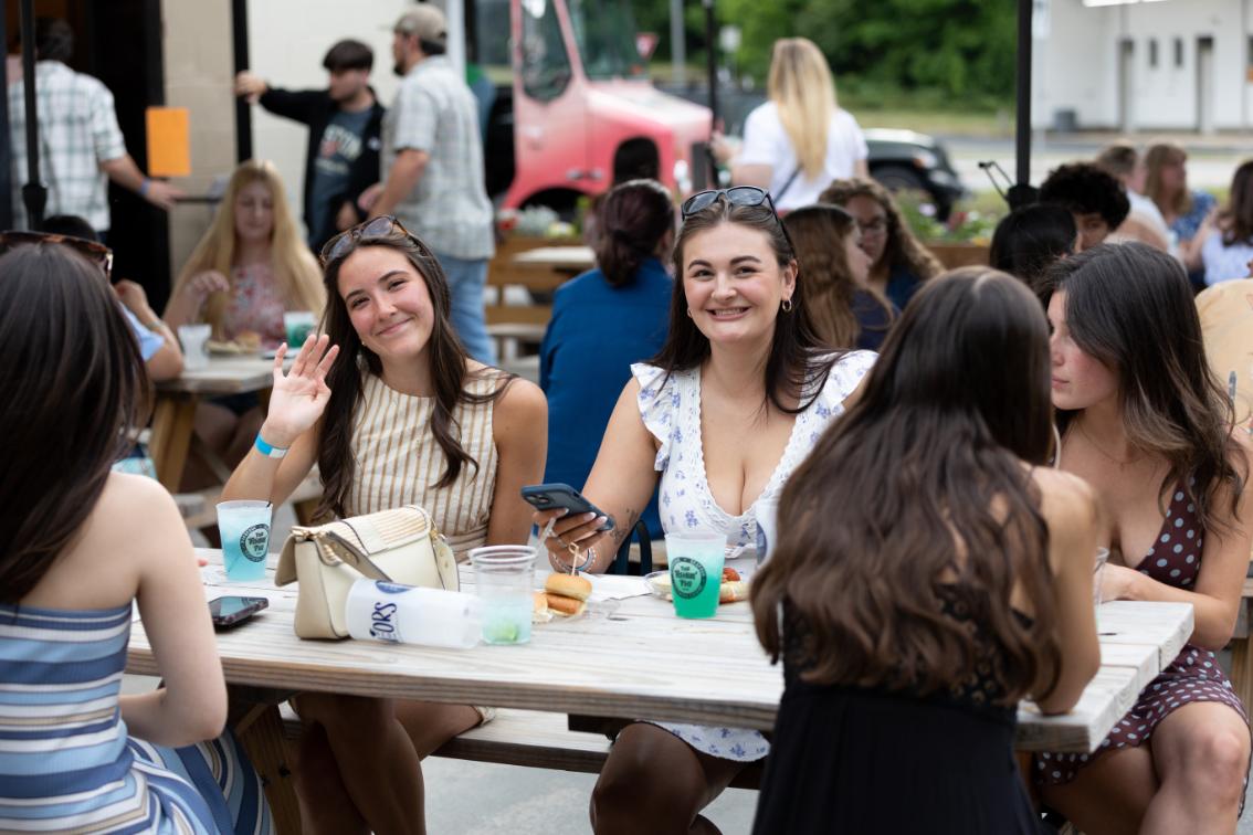 Longwood seniors gather around a table during a Senior Week event in Farmville.