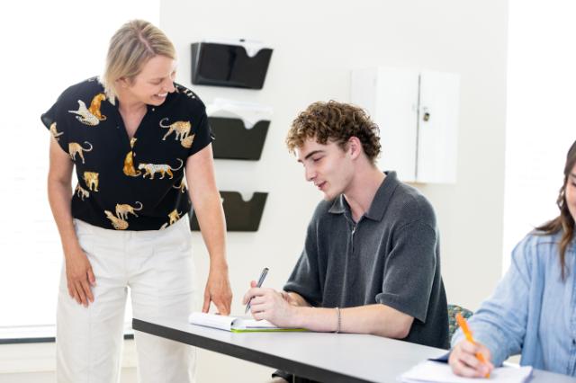 A Longwood faculty member talks with a student during class.
