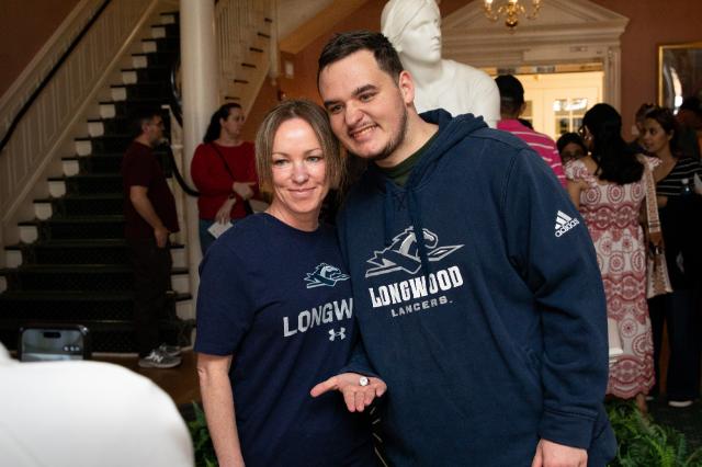 A Longwood student displays his class ring while posing with a guest at the Class Ring Ceremony.