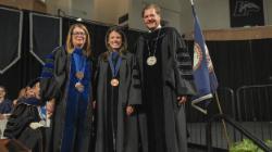 Longwood faculty in academic regalia stand on stage during Convocation