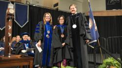 Longwood faculty in academic regalia stand on stage during Convocation