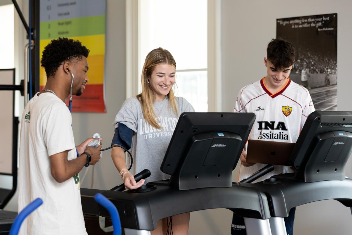 Longwood kinesiology students take blood pressure during treadmill exercise testing
