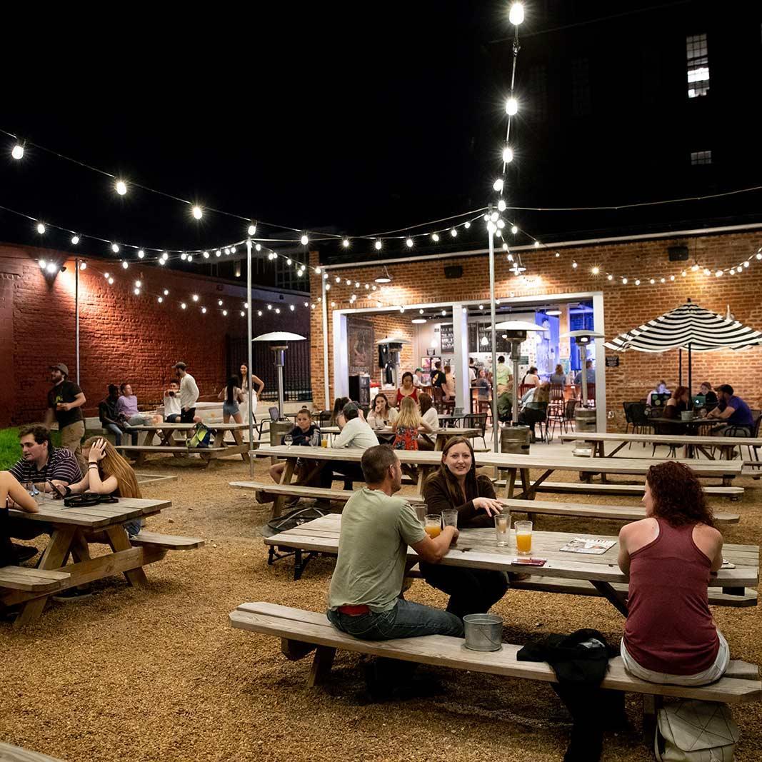 Evening patrons in the beer garden of Three Roads brewing.