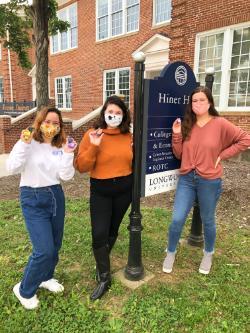 Students with decorated rocks in front of the Hiner