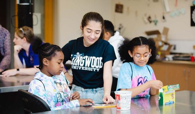 Longwood student working with school children during a Lancer for the Day event