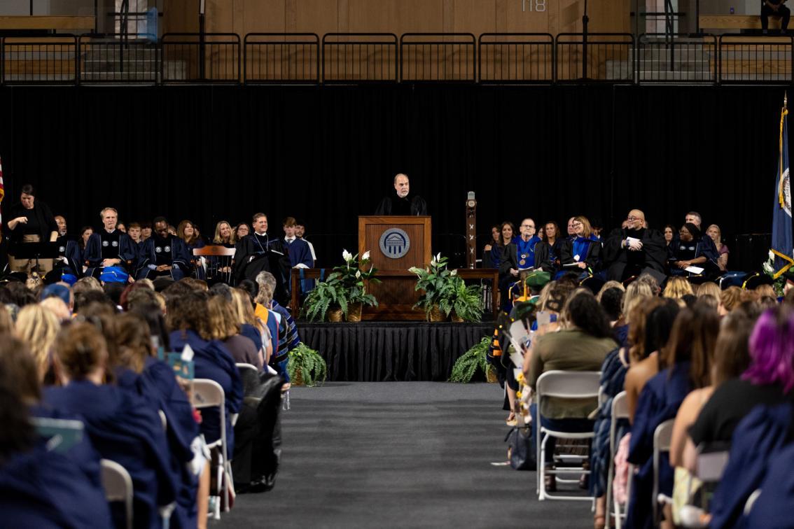 Robert “Bob” Wertz Jr. ’85 on stage speaking at Convocation