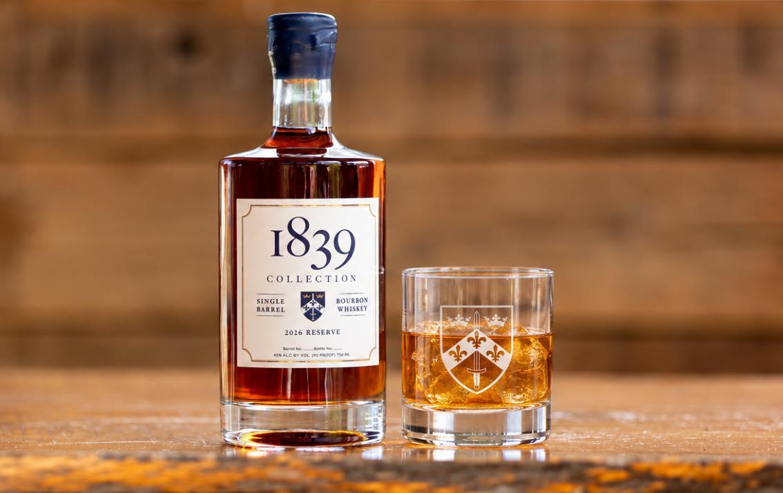 A bottle of Longwood’s 1839 Collection 2026 Reserve bourbon stands beside a rocks glass filled with bourbon and ice, featuring Longwood’s Coat of Arms.