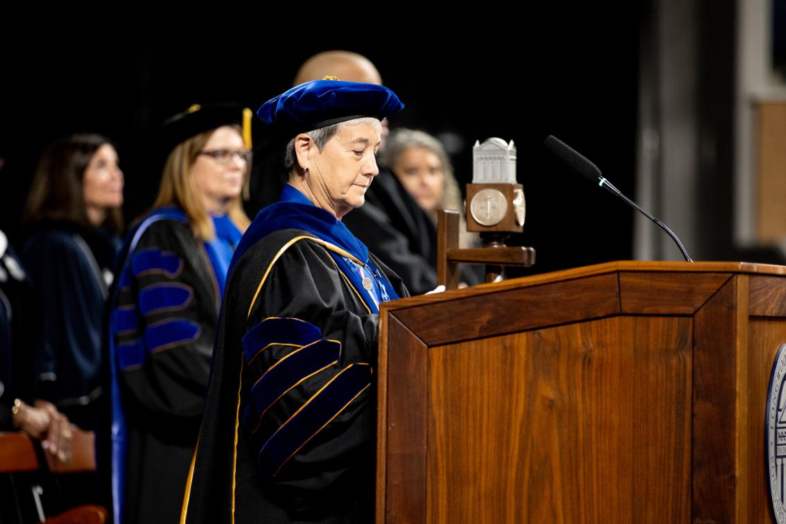 Longwood's chief faculty marshal and professor of school librarianship, Dr. Audrey Church, opens Convocation 2026 after placing the university mace (behind Dr. Church) in its stand.