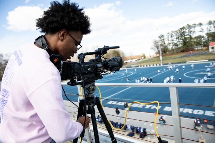 Jesse Turner '28 goes through a pre-game check before the start of a Longwood lacrosse broadcast on ESPN+.