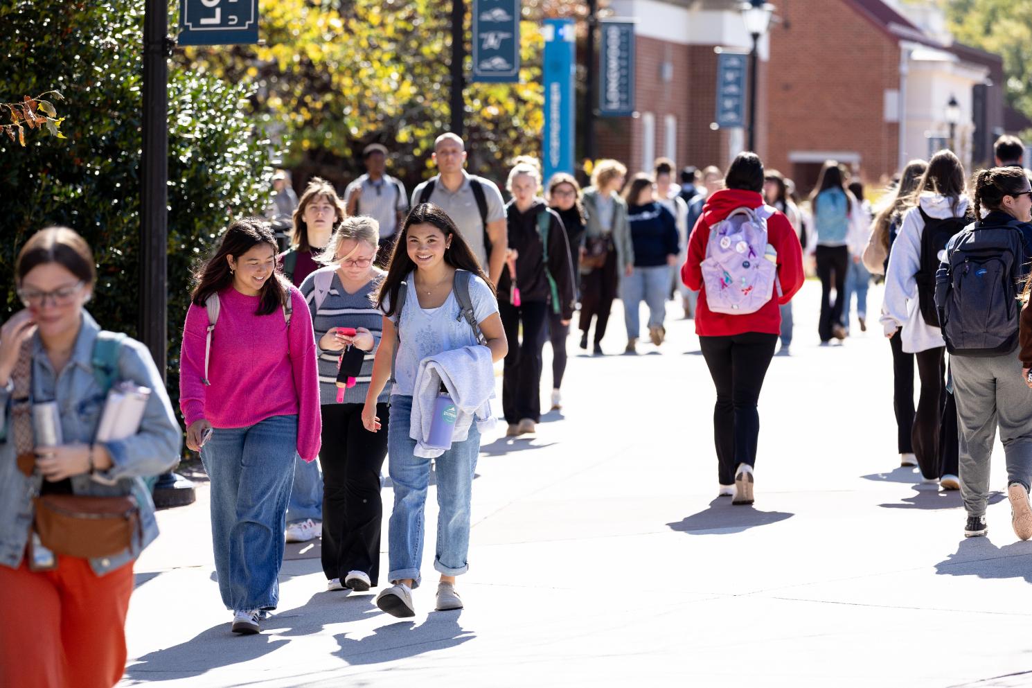 Colorfully dressed students walk down Brock Commons
