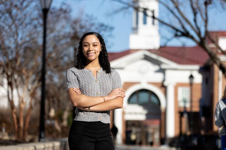 Naiya Casimiro '27 poses with Allen Hall in the background